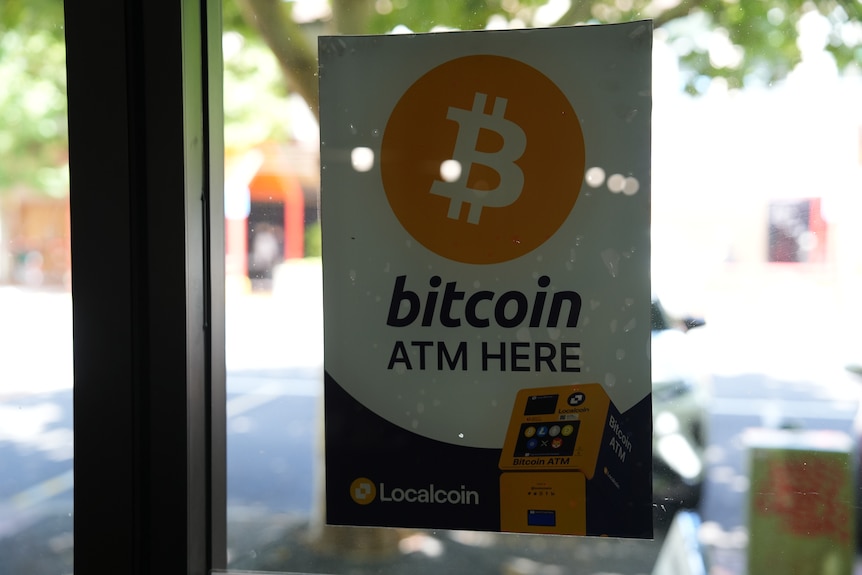 A sign displays "Bitcoin ATM here".