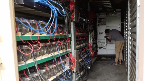 Bitcoin mine interior with computers and wires