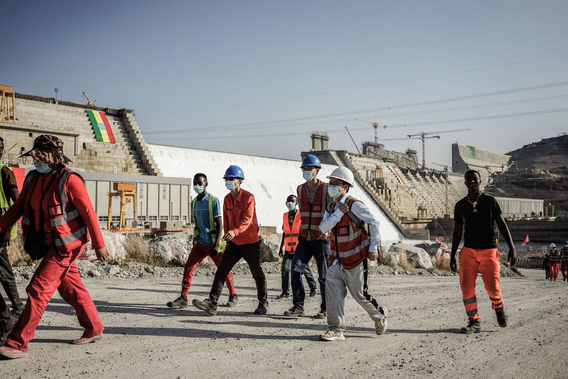 Worker walk at the site of the Grand Ethiopian Renaissance Dam (GERD) in Guba, Ethiopia, on February 19, 2022.