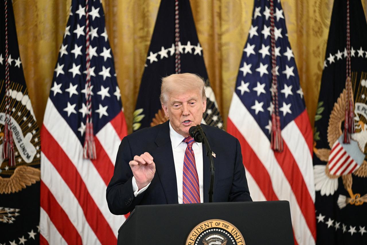 US President Donald Trump delivers remarks before signing the GENIUS Act (Guiding and Establishing National Innovation for US Stablecoins Act). This act codifies the use of stablecoins - cryptocurrencies tied to stable assets such as the US dollar or US bonds, in the East Room of the White House in Washington, DC, on July 18, 2025. (Photo by Brendan SMIALOWSKI / AFP)