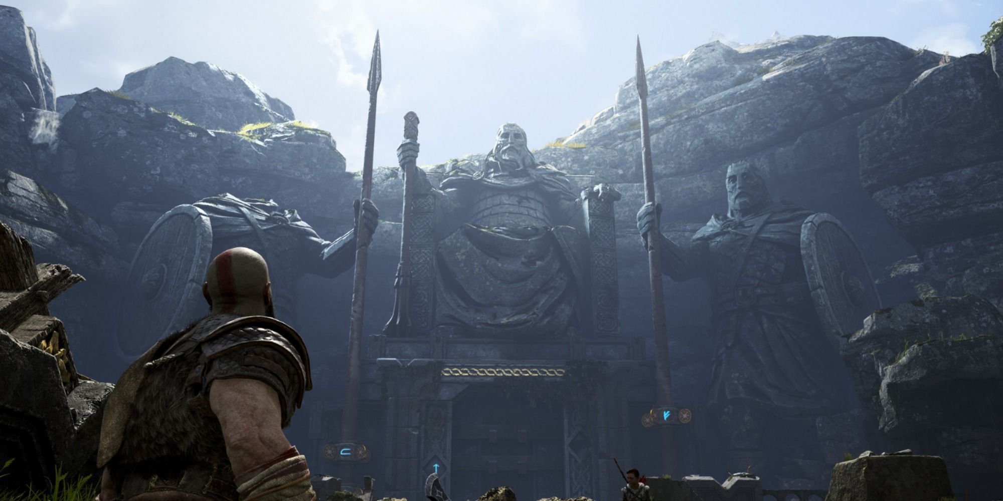 Kratos in a hall of warrior statues in God of War.