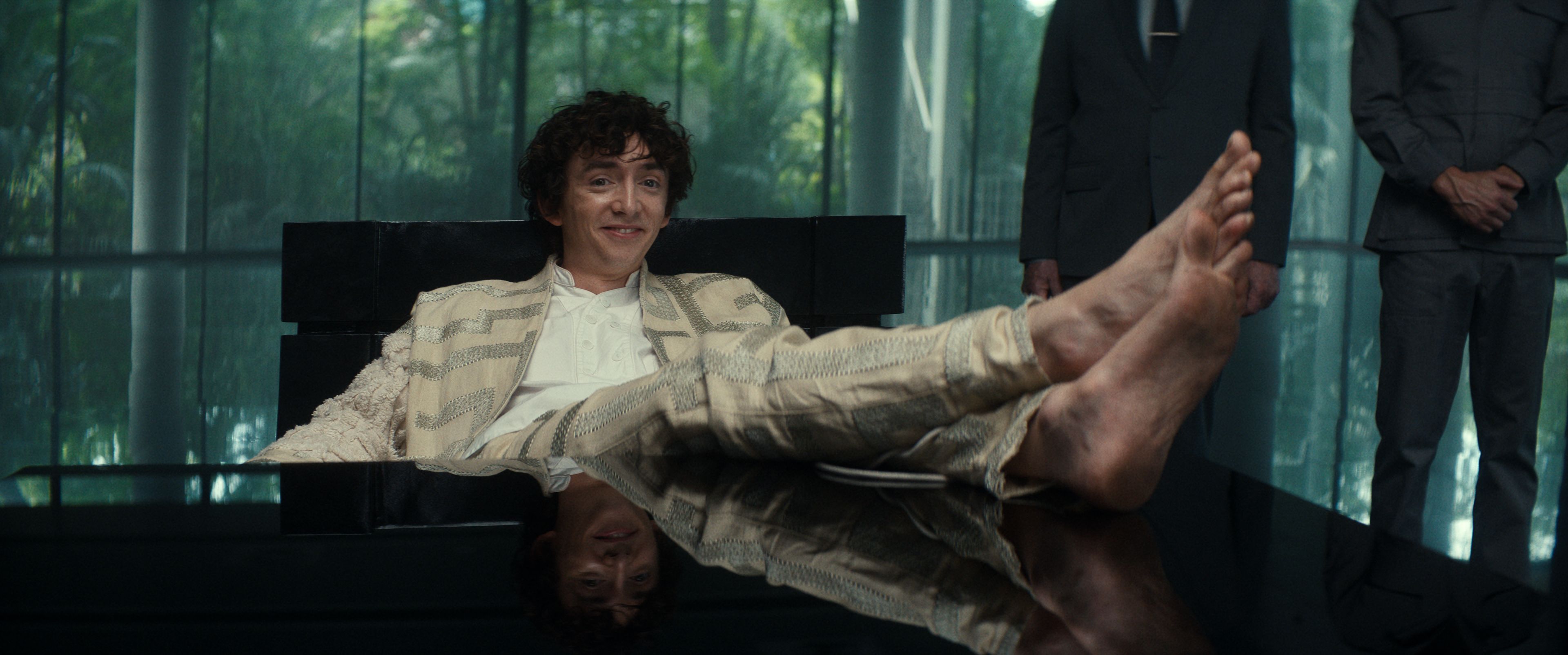 "Youngest trillionaire ever" Samuel Blenkin (Boy Kavalier) poses in an office with his dirty, bare feet up on a desk in Alien: Earth.