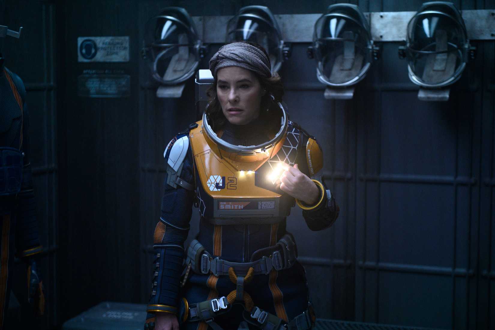 Parker Posey in a spacesuit without helmet looking scared in Lost in Space season 2