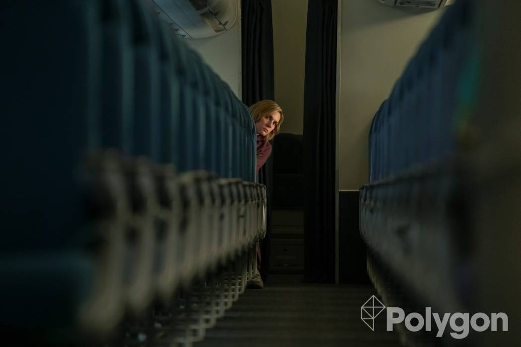 Rhea Seehorn sitting in the back of an empty airplane in Pluribus