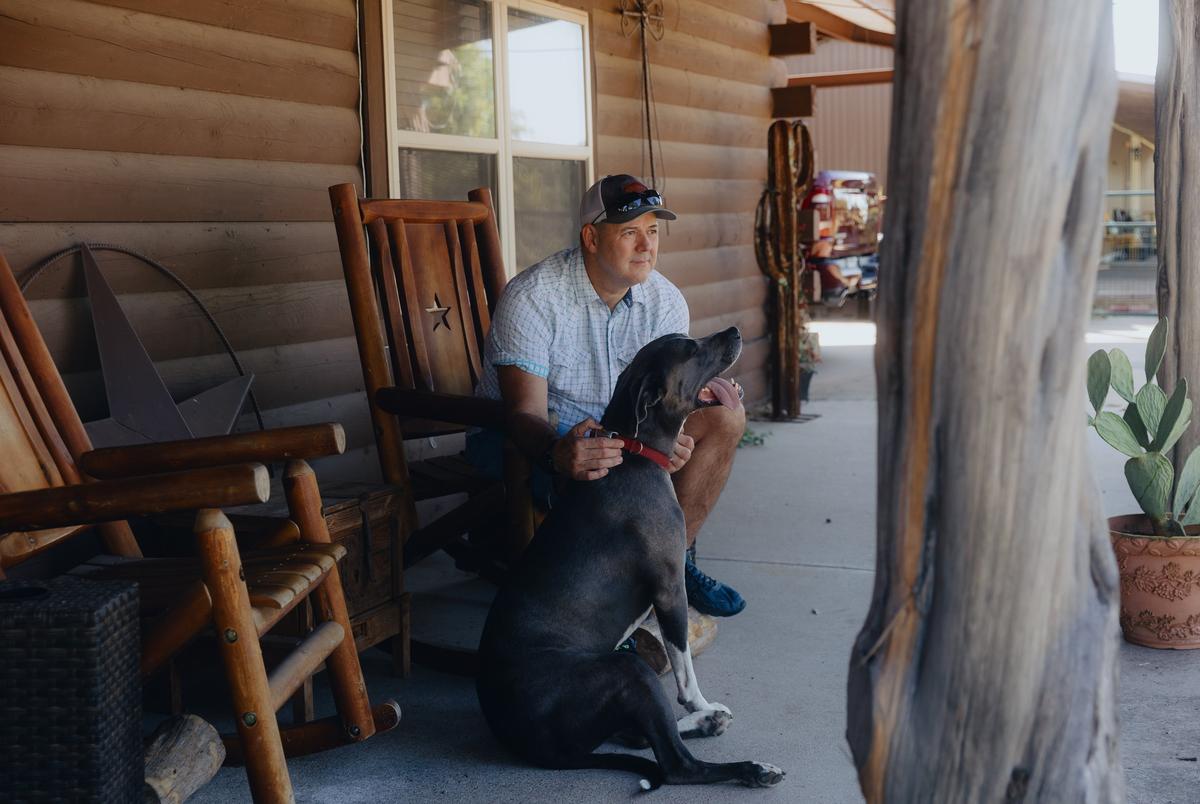 Danny Lakey and his dog Jax on his porch at his home in Hood County on September 25, 2025.